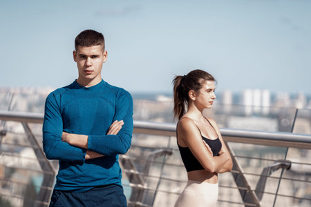 Teamwork workout activity concept. Confident young adult sportsman looking at camera crossed hands...
