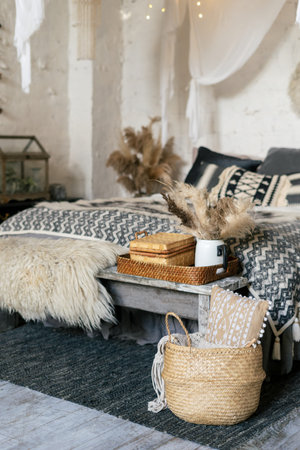 Still life concept. Vertical photo of cozy apartment in boho style interior with comfort bedroom,...