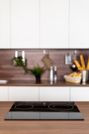 View of the contemporary interior with wooden countertop and empty surface on ceramic glass stoveの写真素材