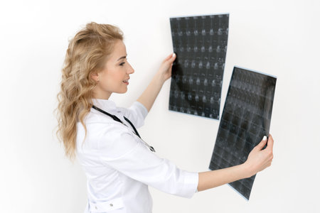 Medicine and healthcare concept. Woman doctor in white medical uniform holding magnetic resonance...
