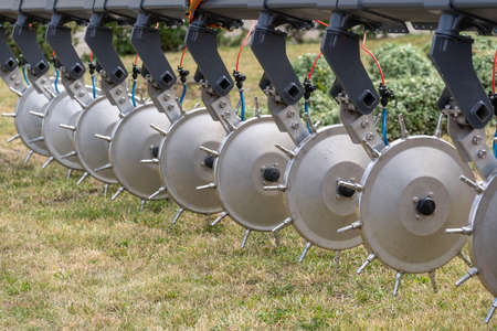 Close up shot of modern tractor sprayer or irrigation machine made of stainless steel for supplying water to field. Modern agricultural and farming equipment conceptの写真素材