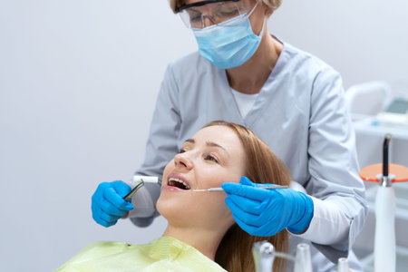 Side view of doctor treating patients teeth using dental instruments. oral medicine. Dentistry...