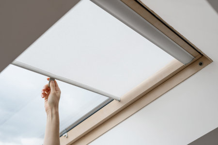 advertising concepts. Side view of woman hand open blinds on attic or mansard window in wooden frame...