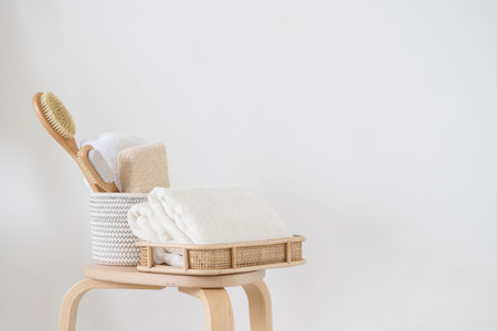 Massage brush, sponge, pumice and fresh towels in the bathroom. Morning routine set against white...
