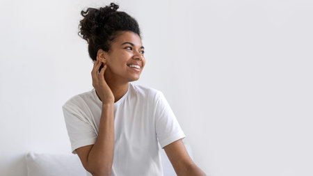 Portrait of a beautiful african american woman looking to the side. Sexy lady posing at home on...