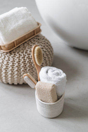 Vertical shot of bathroom towels, massage body brush and eco friendly toiletries for natural beauty...