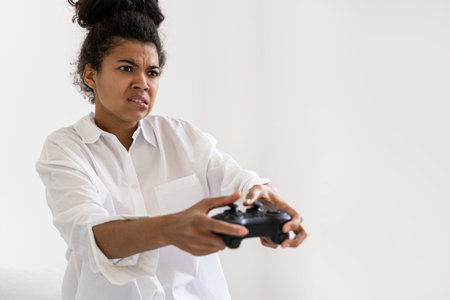 Portrait of afro american holding joystick when playing videogame. Virtual reality concept. Leisure...