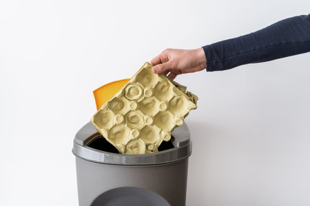 Cropped view of person throwing paper into trashbin. Garbage recycling. saving planet. environmental...
