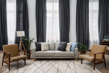 Cozy living room with retro style decor, vintage furniture, cushions on comfortable couch, armchairs...