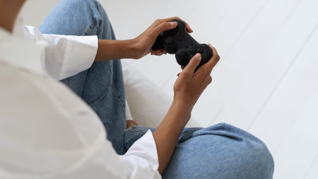 High above view of afro american holding joystick when playing videogame. Virtual reality concept....