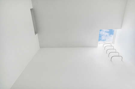 Low angle view of white modern space in building with stair access to the roof close to skylight, mansard window. Residential and commercial architecture design. Construction industry, advert conceptの写真素材