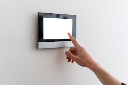 Wireless technology for managing smart devices at home concept. Woman hand check security and...