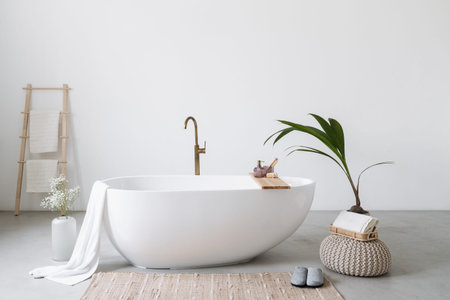 White modern tub in minimalistic bathroom interior. Porcelain bathtub with classic design in a...