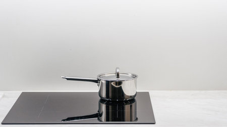 Cooking food on modern cooker hob. Advertising concepts of built-in appliances on minimalistics...