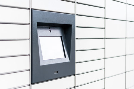 Side view of white automatic post terminal with self service. Postal cells with locked doors. Touch...