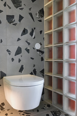 interior design in apartment or closeup of ceramic white wc toilet with closed lid and hidden water...