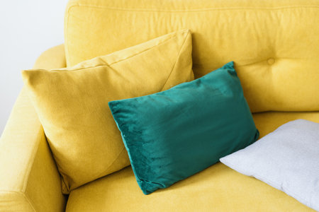 modern velvet couch with bright yellow color upholstery in living room for comfort rest and relaxの写真素材