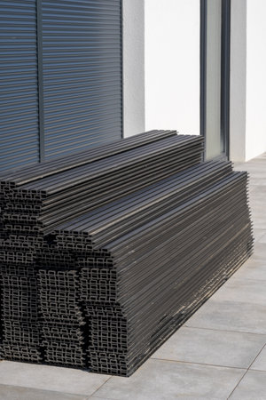 stack of stainless steel rectangular pipe near workshop with automatic system for opening metal garage doorsの写真素材