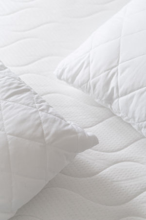 top view of new hypoallergenic cushions on foam orthopedic mattress on bed, comfort sleeping concept, cotton textile surface, closeupの写真素材