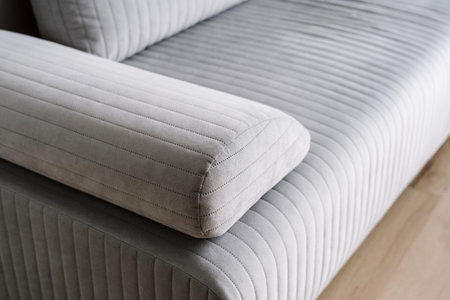 closeup of luxury couch with grey upholstery and comfortable armrest in store, repair and restoration furniture concept, dry cleaning serviceの写真素材