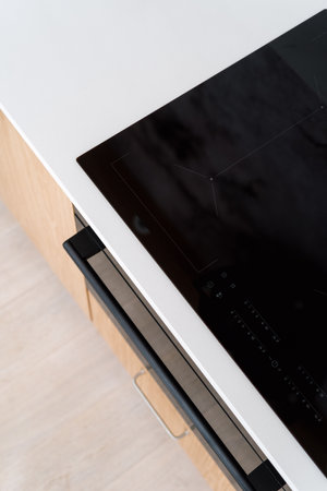 top view of glass ceramic cooker top with indicators and sensor buttons on control panel at modern kitchen room in apartment, household appliances conceptの写真素材