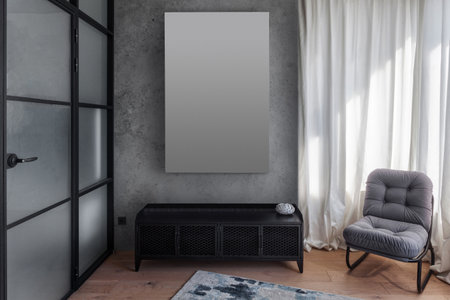detail in living room with loft interior. black commode, comfort armchair, picture with copy space hanging on concrete wall, wooden floor with rug and glass door in bedroomの写真素材