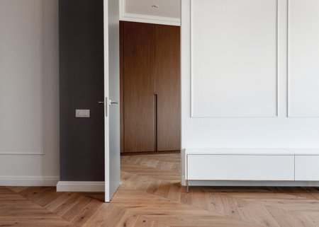 empty room with wall decoration in classic style and wooden laminate floor in renovated house. idea of interior design for new living spaceの写真素材