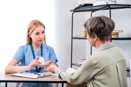 Female general practitioner recommend pill for patient. Doctor getting new prescription to cure chronic disease. Effective innovative medication. Bottle with pharmaceuticals drugsの写真素材
