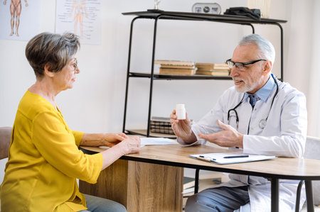 Therapist prescribing drugs medications to mature woman at appointment. Doctor giving recommendations for disease prevention in private clinic. Healthcare and medicine concept.の写真素材