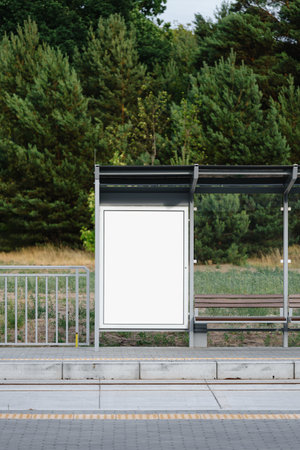 Vertical front shot of public bus stop for city transport with white canvas on billboard or lightbox. Station with template placard for commercial advertising. Urban infrastructure, commercial, promoの写真素材