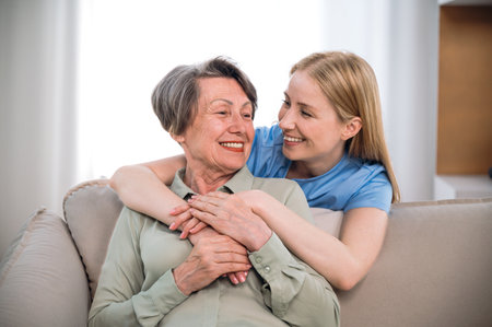 Medical care. Nurse or volunteer social worker hug with happy patient, looking to each other. Concept of healthcare or physiotherapy. Charity, caregiver support at nursing home for elderly peopleの写真素材