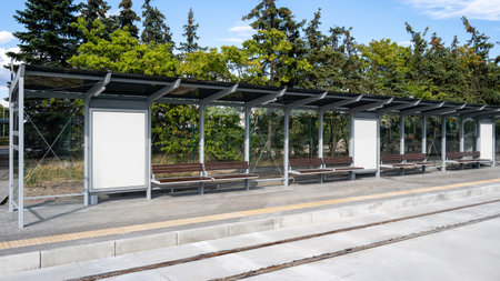 Side view with empty copy space banner poster in public transport stop against nature on background. Bus shelters with waiting bench template city lightbox for commercial advertisingの写真素材