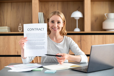 Female point at insurance document showing where write signature. Woman with employment contract or purchase agreement make financial business deal in office. Term, condition for sale house, rent carの写真素材