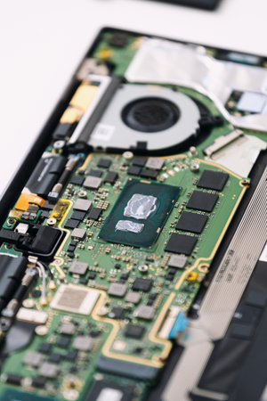 Vertical shot of detailed view of the intricate motherboard inside a laptop, showing various components and connectors. Microchip and electronic chip inside digital tablet computer. Repair serviceの写真素材