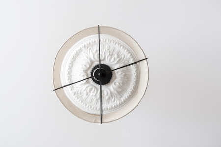 Classic white ceiling lamp light decoration for home and living room with copy space for text. Baroque style with stucco and floral ornament around lampshade. Interior elements in bedroom, low angleの写真素材