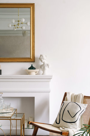 Cushion on wooden chair. Modern living room with decorative white fireplace. Comfort armchair...