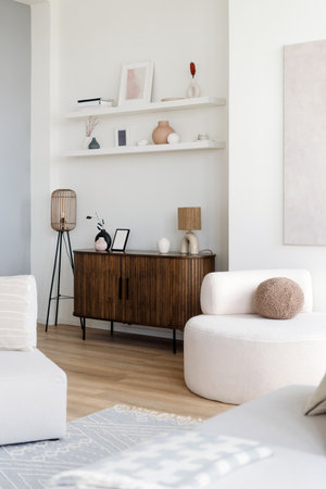 A cozy living room showcases a wooden sideboard paired with minimalist decor, comfortable soft furniture and warm lighting, creating a welcoming atmosphere at homeの写真素材