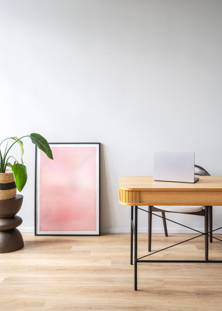 This modern workspace showcases a wooden desk with a laptop, surrounded by a green plant and a...