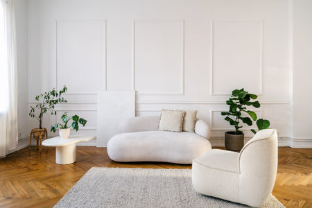 This stylish living room features a vintage white sofa and a cozy armchair, set against a minimalist...