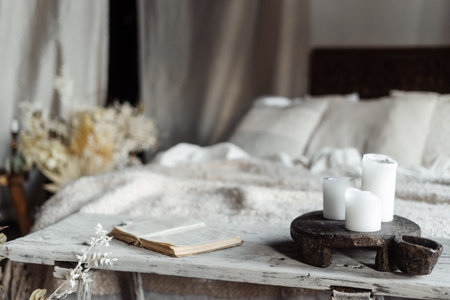 This charming bedroom features a comfortable bed adorned with soft white linens, a rustic bench...