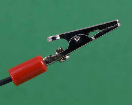 A close-up of an alligator clip for electrical connections.