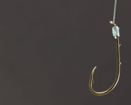 A close-up of a fishing hook on fishing line.の写真素材
