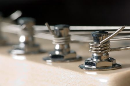 A macro shot of electric guitar machine heads used for tuning strings.の写真素材