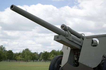 A military cannon against a cloud filled sky.の写真素材