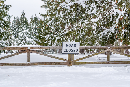 Winter Road Closed to traffic by a wooden barricade.の写真素材