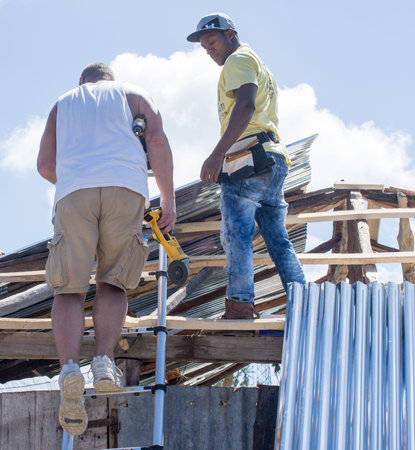 Men working on Village of Bonbon Haiti homes after hurricane Matthew destroyed it in October 2016.