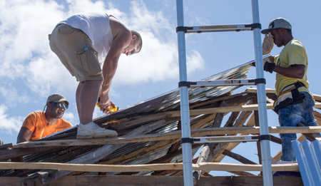 Men working on Village of Bonbon Haiti homes after hurricane Matthew destroyed it in October 2016.のeditorial素材