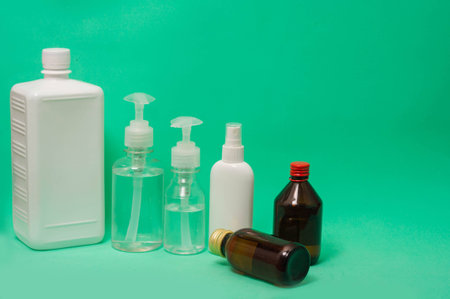 Bunch of different sanitizers on green backgroundの写真素材
