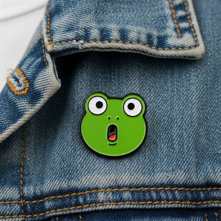 Funny green smiley frog pin in jeans pocket, closeupの素材
