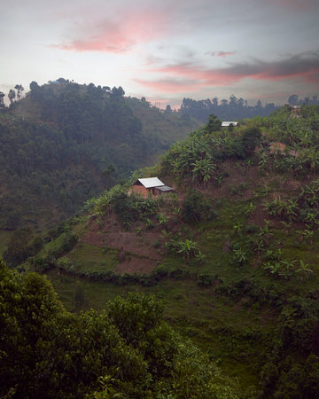 Isolated house sitting atop mountain at sunset.